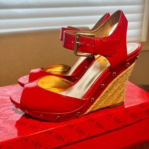 “Guess” platform-wedge heel. Beautiful Red patent with gold buckle and details.